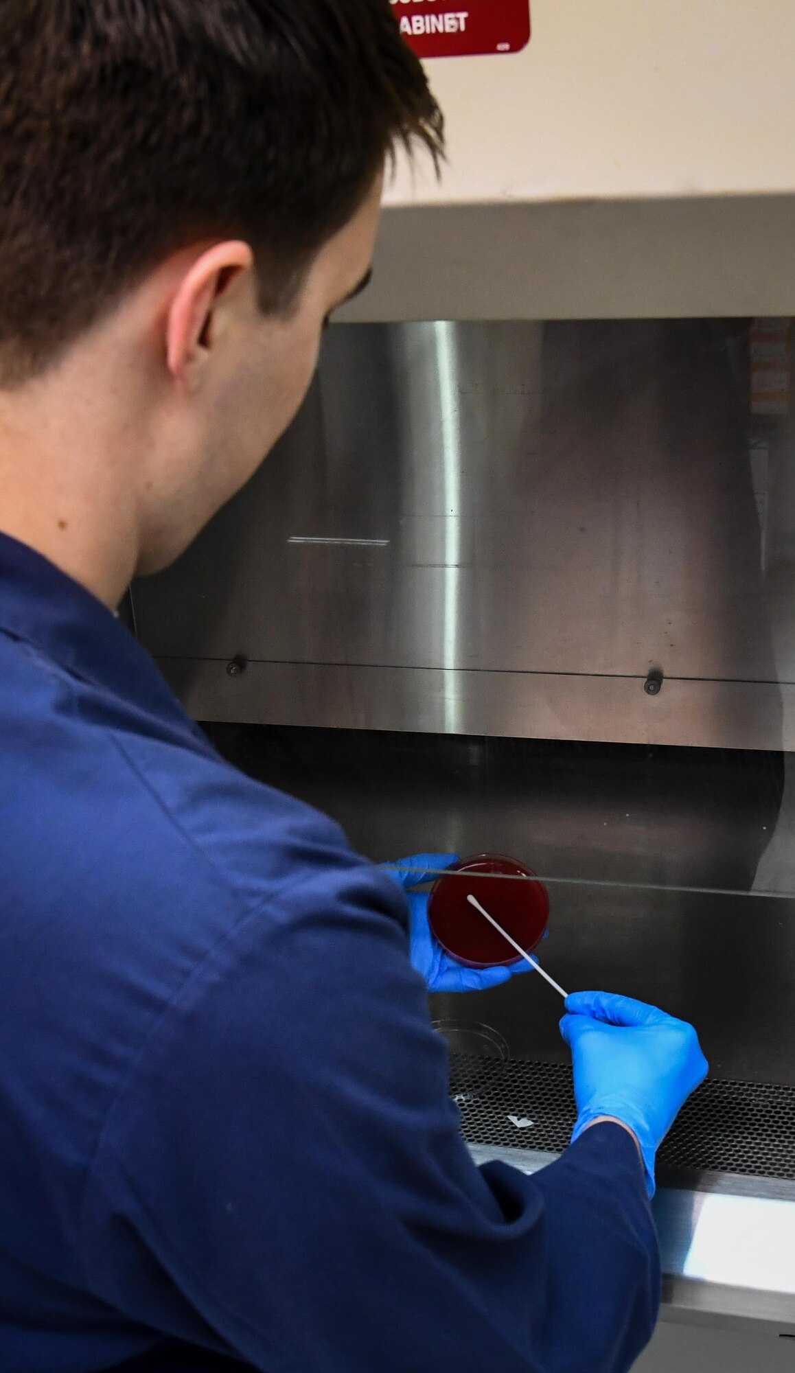 Senior Airman Josef Ansorge, 2nd Medical Group laboratory technician, places a sample onto a container at Barksdale Air Force Base, La., Aug. 2, 2017.