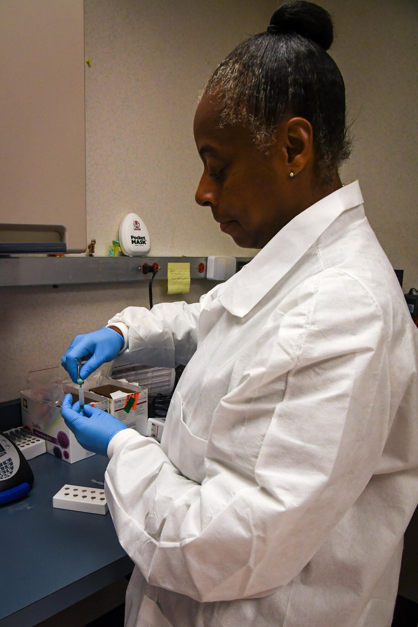 Master Sgt. Nordyica Woodfork, 2nd Medical Group laboratory technician, removes a specimen from a collected sample at Barksdale Air Force Base, La., Aug. 2, 2017.