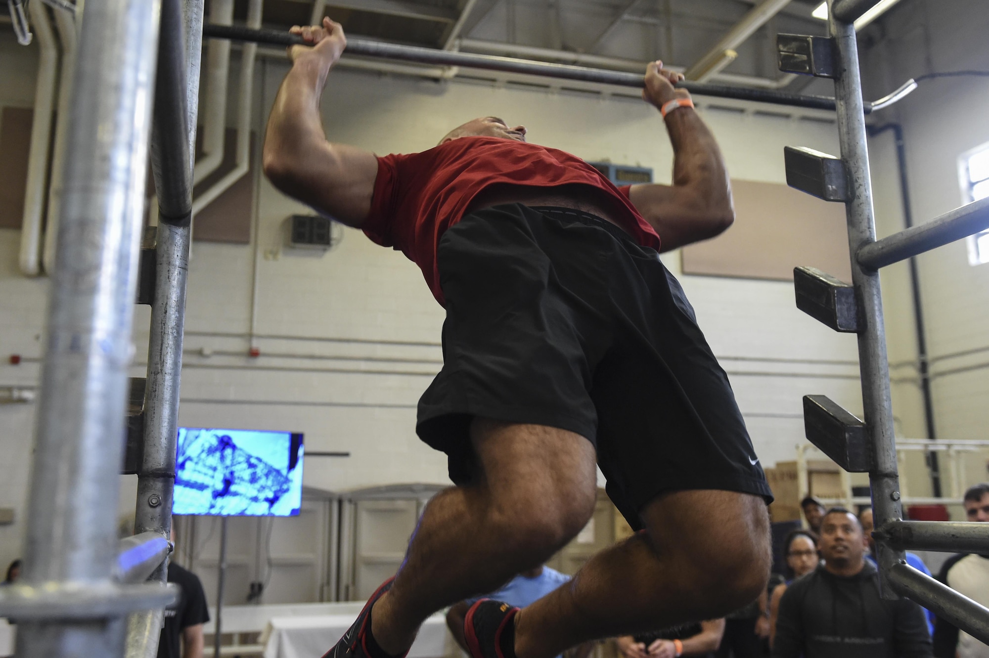 Tech. Sgt. Paul Woody, 437th Aircraft Maintenance Squadron special operations element chief, tries out the Alpha Warrior Battle Rig’s salmon ladder during its introduction on the Globemaster Court at the Air Base Fitness and Sports Center on Joint Base Charleston, S.C., Aug. 5.