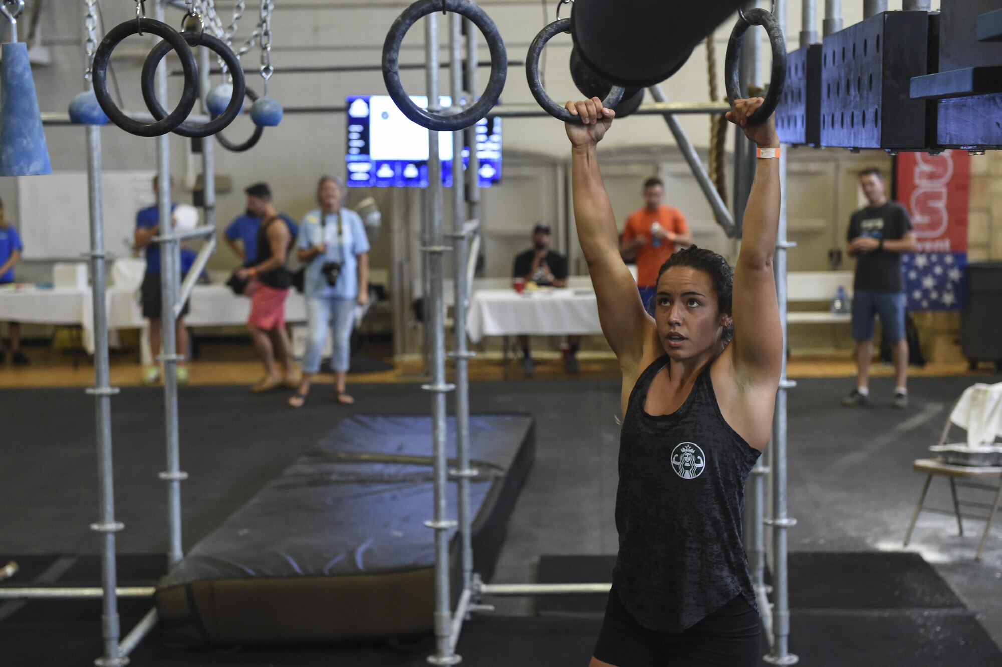 U.S. Coast Guard Fireman Jaimie Mechikoff, Aid to Navigation Teams Charleston fireman, tries out the Alpha Warrior Battle Rig during its debut on the Globemaster Court at the Air Base Fitness and Sports Center on Joint Base Charleston, S.C., Aug. 5.