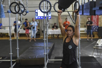 U.S. Coast Guard Fireman Jaimie Mechikoff, Aid to Navigation Teams Charleston fireman, tries out the Alpha Warrior Battle Rig during its debut on the Globemaster Court at the Air Base Fitness and Sports Center on Joint Base Charleston, S.C., Aug. 5.