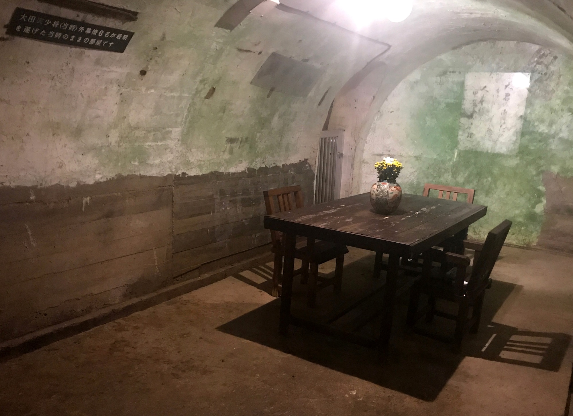 The commanding officer's room in the Former Naval Japanese Underground Headquarters, a table with 2 chairs.