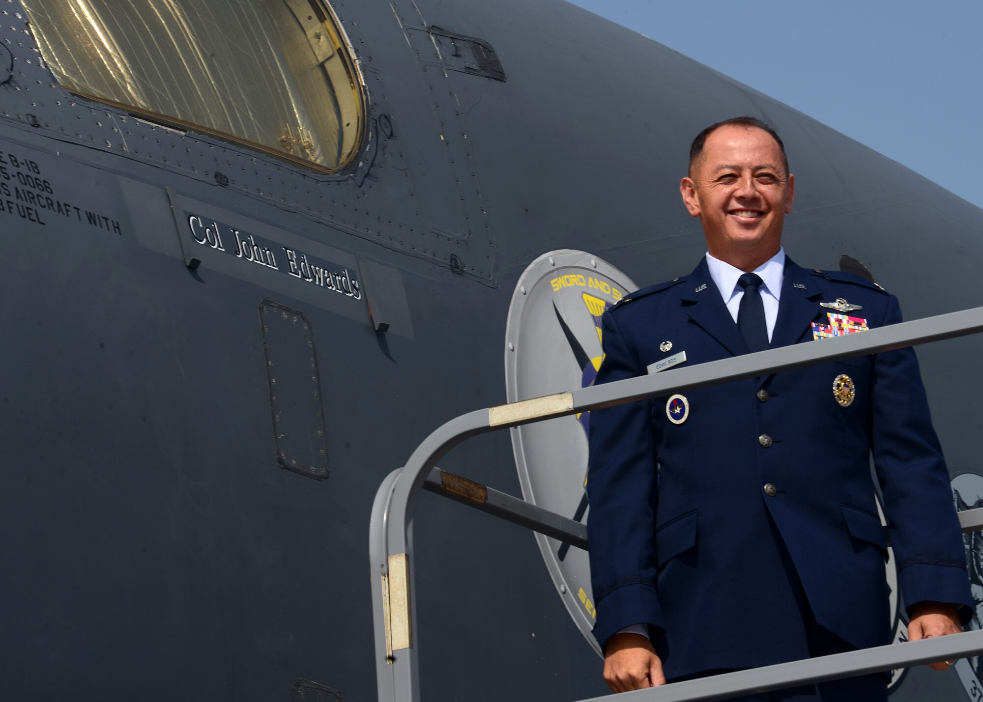 Col. John R. Edwards, commander of the 28th Bomb Wing, unveils his name on a B-1 bomber at Ellsworth Air Force Base