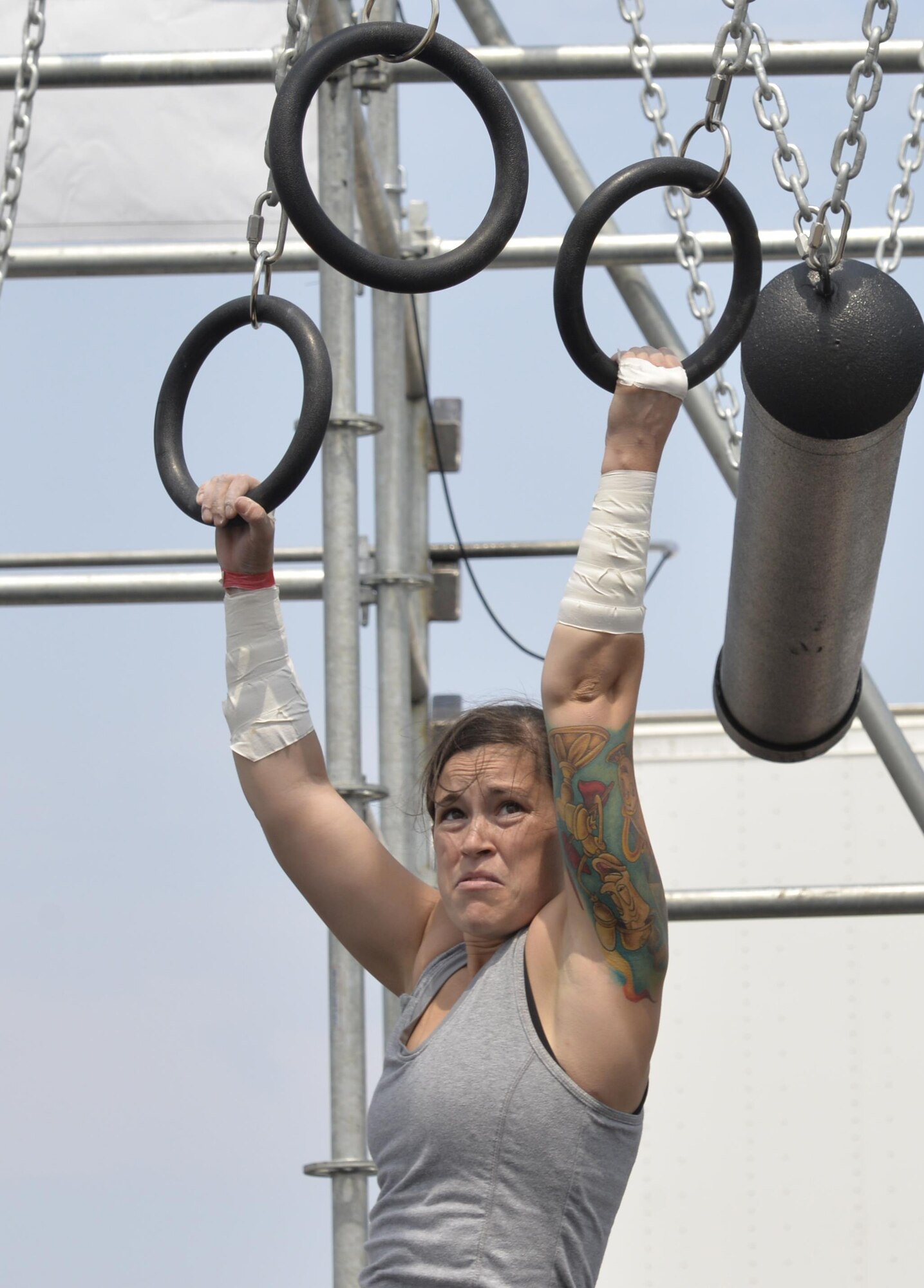 Staff Sgt. Amanda Hood, non-commissioned officer in charge of admin support assigned to Ellsworth’s Office of Special Investigations, pushes herself to complete the Alpha Warrior Battle Rig course, at Ellsworth Air Force Base, S.D. on Aug. 5, 2017.  The course required immense physical strength in order to be completed. The Battle Rig consisted of five strength testing obstacles, requiring participants to swing, climb and lift their way to the finish. (U.S. Air Force photo by Airman 1st Class Michella T. Stowers)
