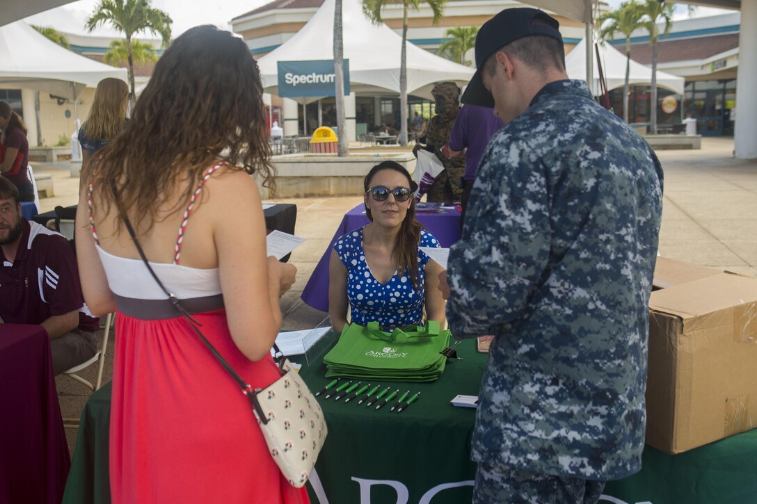 U.S. Marines, Sailors, spouses, and DoD employees visited more than 20 tables to learn about college courses available after work and/or online classes. This is one of many services that the Education Center provides for active duty service members, family members, veterans, and DoD civilians on base to assist with starting or completing journeys towards a college degree or certificate program. (U.S. Marine Corps photo by Cpl. Zachary Orr)
