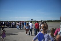 People from across the Fairbanks North Star Borough gather to watch an F-16 fighting Falcon aircraft assigned to the 18th Aggressor Squadron (AGRS) perform a maneuver during the Eielson Air Force Base, Alaska, Open House, August 5, 2017. The event featured U.S. Air Force, Army, Navy and Royal Canadian Air Force Assets, as well as a fly-over performed by the 18 AGRS. (U.S. Air Force photo by Airman 1st Class Isaac Johnson)