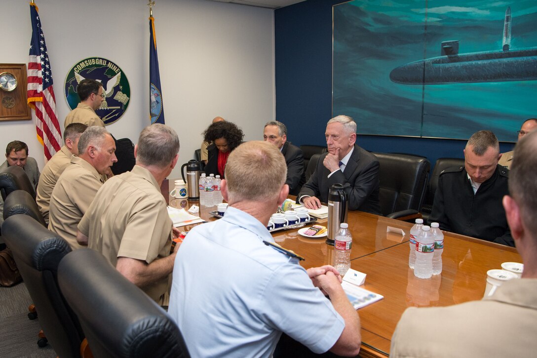 Defense Secretary Jim Mattis sits at a table with military leaders.