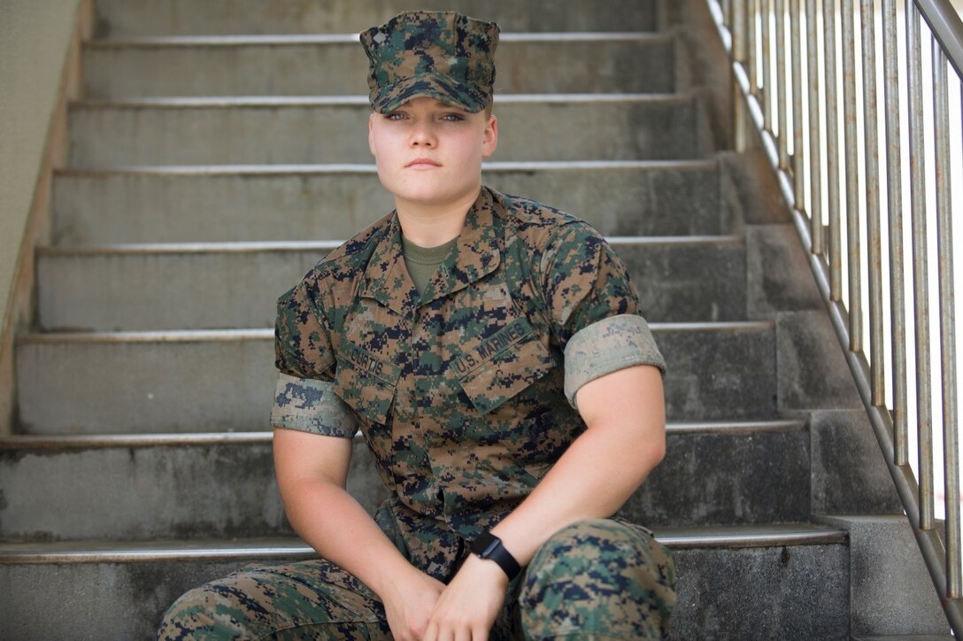 Lance Cpl. McKenzie A. Curtis poses for a picture on the stairs Aug. 9 aboard Camp Foster, Okinawa, Japan.