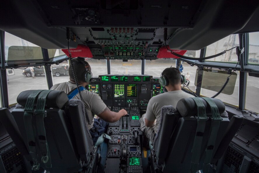 alt=Crew chiefs from the 374th Aircraft Maintenance Squadron perform post-flight inspections