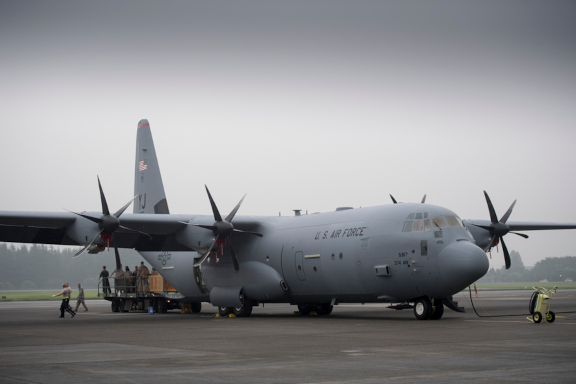 alt=Crew members from the 36th Airlift Squadron unload pallets