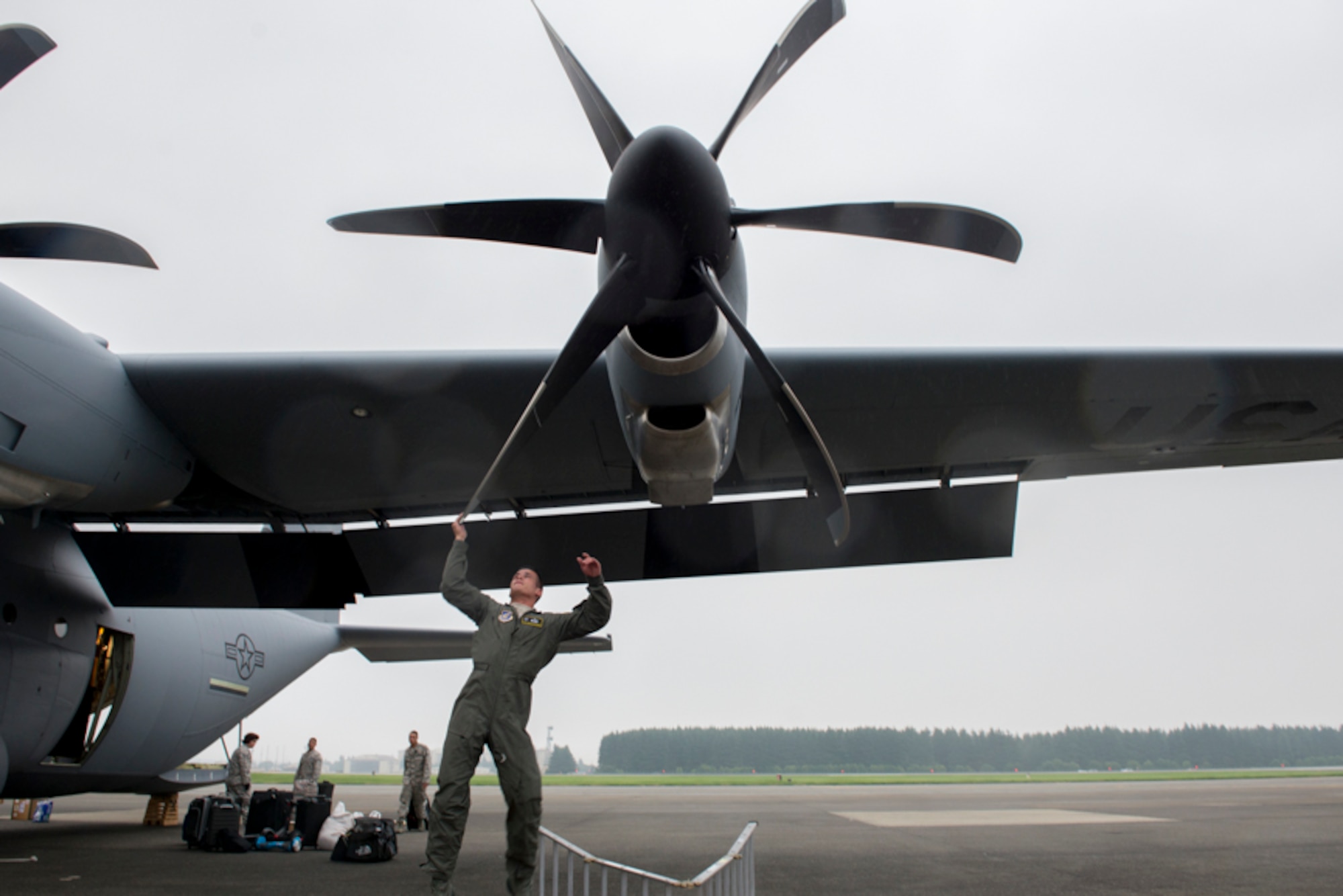 alt=Staff Sgt. Christopher Rivera, 374th Aircraft Maintenance Squadron flying crew chief, adjusts propeller position on a C-130J Super Hercules