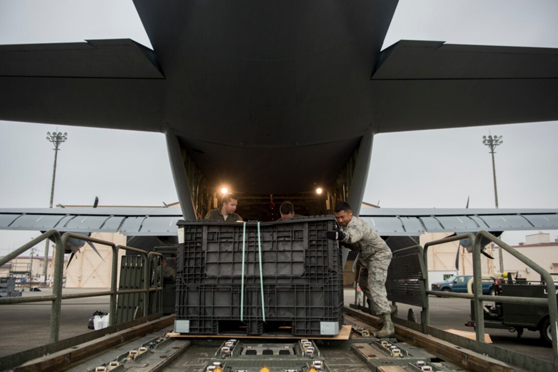 alt=Airman from the 374th Operations Group unload cargo from a C-130J Super Hercules