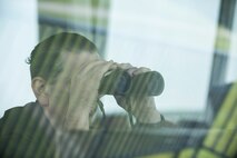 Mike Guerra, a Draughon Range electronic warfare field engineer, watches aircraft hit targets at Draughon Range it Misawa City, Japan, Aug. 2, 2017. Along with the upkeep of the range, personnel assist pilots with their training by telling them how far and fast their precision is each time they pass through the target field. Any time the range is in use, personnel brief all pilots the types of ammunition they are allowed to use.  (U.S. Air Force photo by Airman 1st Class Sadie Colbert)