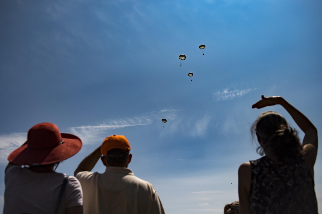 Spectators watch as paratroopers glide during Leapfest, Aug. 6, 2017, in West Kingstown, R.I. The Rhode Island National guard hosted the 34th annual event, which is the largest international stat-ic line jump competition in the world. Team Moody’s Airmen represented the only U.S. sister-service team and earned second place among 70 participating teams. (U.S. Air Force photo by Air-man 1st Class Daniel Snider)