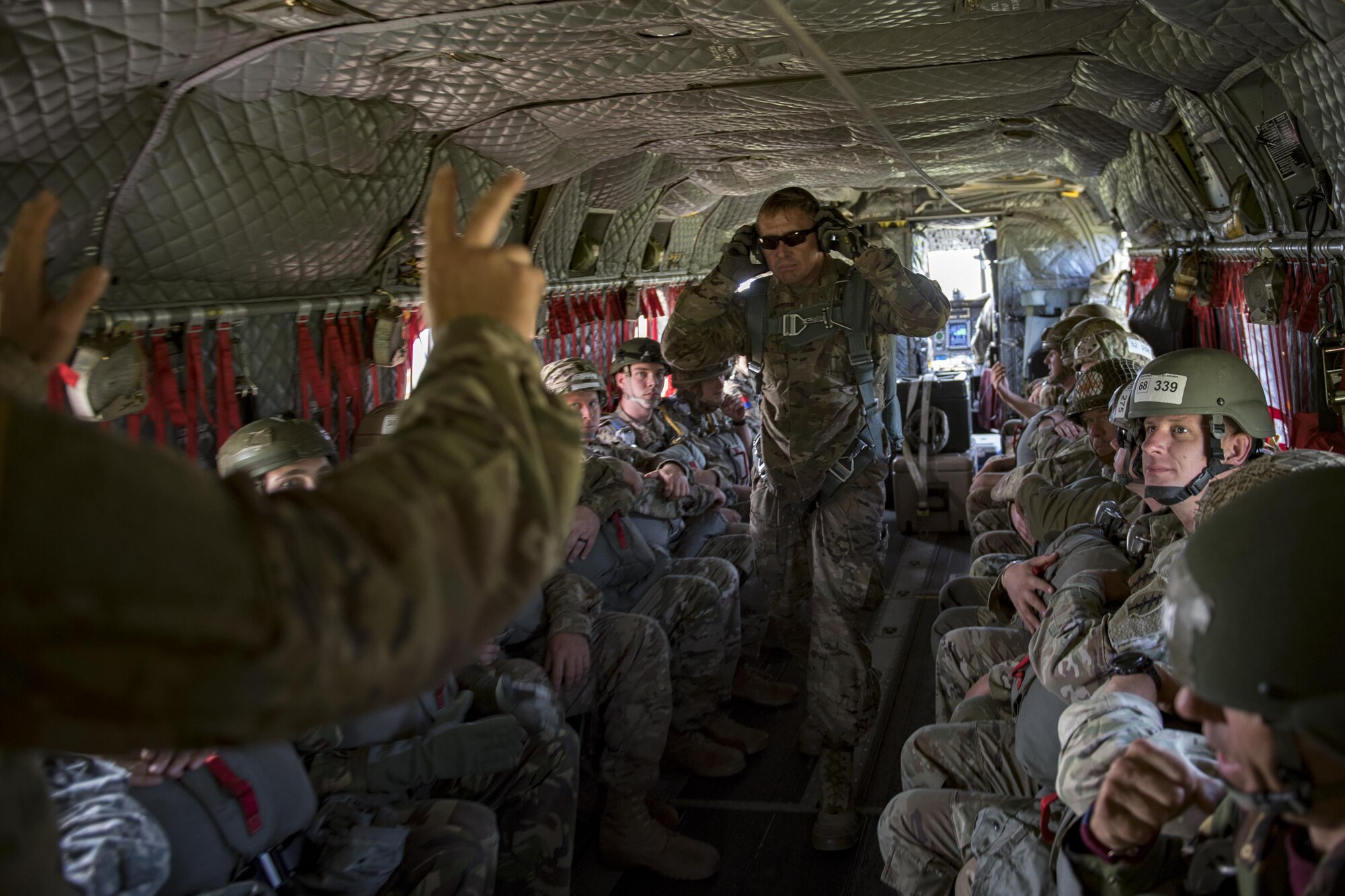 Crew members communicate in a U.S. Army CH-47 Chinook during Leapfest, Aug. 6, 2017, in West Kingstown, R.I. The Rhode Island National guard hosted the 34th annual event, which is the largest international static line jump competition in the world. Team Moody’s Airmen represented the only U.S. sister-service team and earned second place among 70 participating teams. (U.S. Air Force photo by Airman 1st Class Daniel Snider)