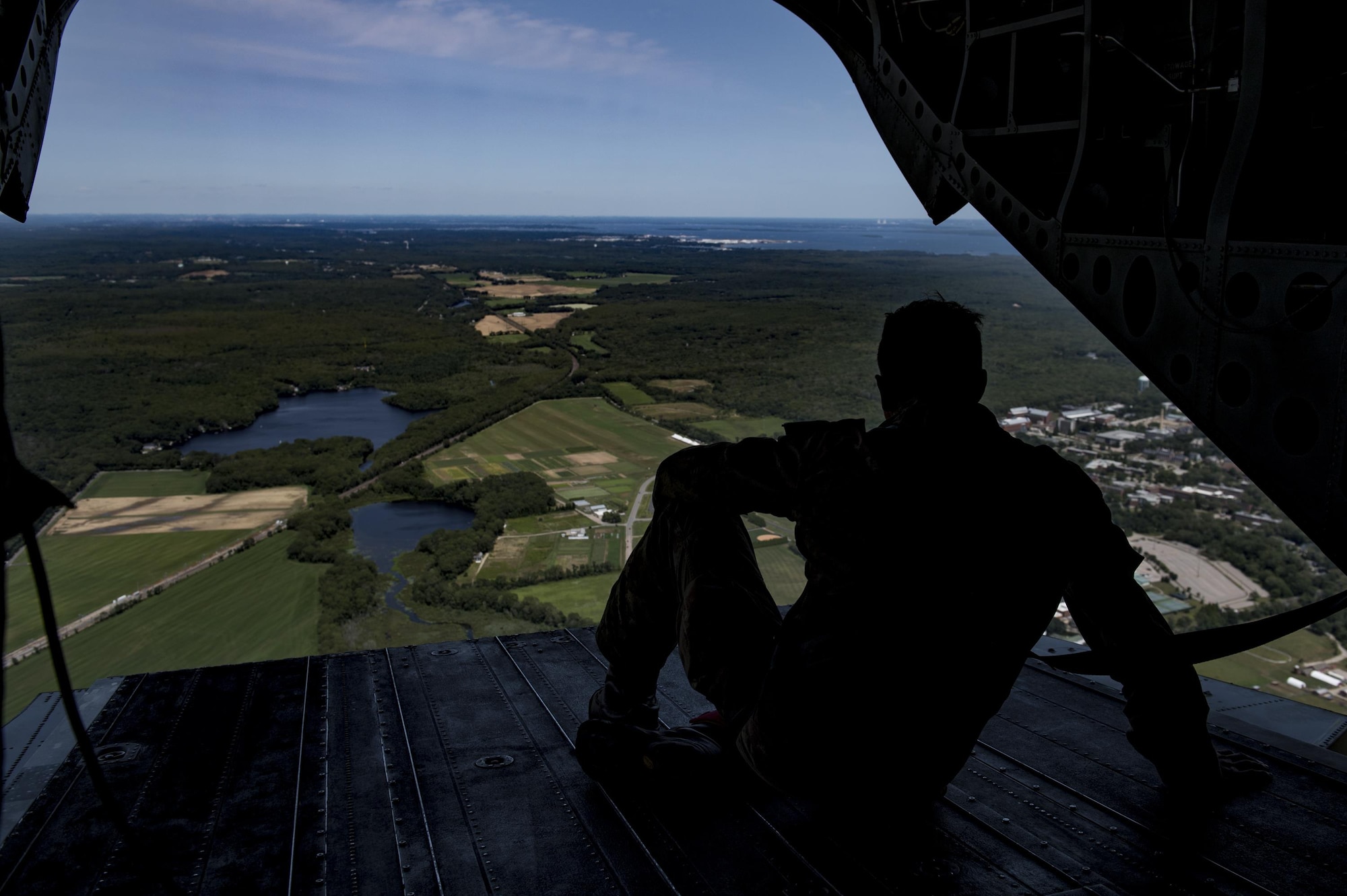 Italian army Lt. Gilberti Pier Luigi, jump master, looks out from the back hatch of a CH-47 Chinook during Leapfest, Aug. 6, 2017, in West Kingstown, RI. The Rhode Island National guard hosted the 34th annual event, which is the largest international static line jump competition in the world. Team Moody’s Airmen represented the only U.S. sister-service team and earned second place among 70 participating teams. (U.S. Air Force photo by Air-man 1st Class Daniel Snider)