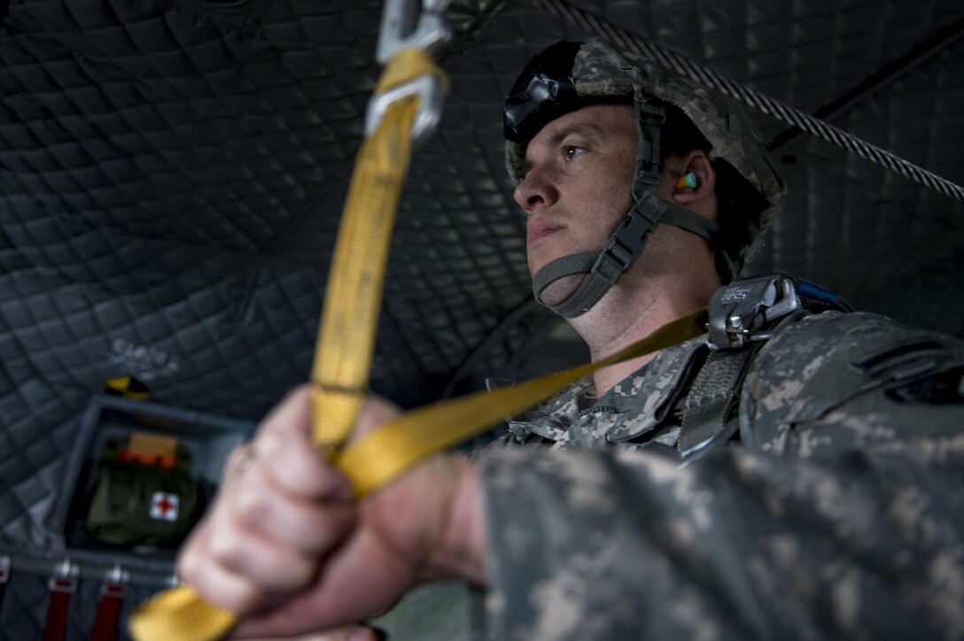 A U.S. Army paratrooper prepares to jump in a U.S. Army CH-47 Chinook during Leapfest, Aug. 6, 2017, in West Kingstown, RI. The Rhode Island National guard hosted the 34th annual event, which is the largest international static line jump competi-tion in the world. Team Moody’s Airmen represent-ed the only U.S. sister-service team and earned second place among 70 participating teams. (U.S. Air Force photo by Airman 1st Class Daniel Snider)