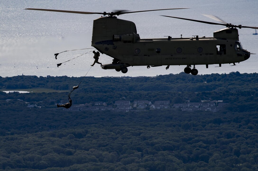 Paratroopers jump from a U.S. Army CH-47 Chi-nook during Leapfest, Aug. 6, 2017, in West Kingstown, R.I. The Rhode Island National guard hosted the 34th annual event, which is the largest international static line jump competition in the world. Team Moody’s Airmen represented the only U.S. sister-service team and earned second place among 70 participating teams. (U.S. Air Force photo by Airman 1st Class Daniel Snider)