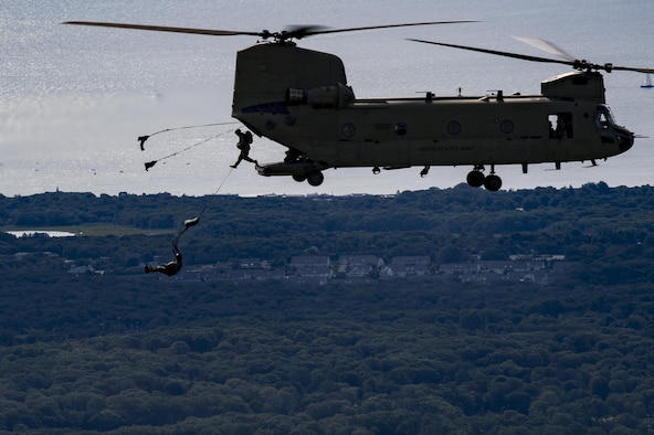 Paratroopers jump from a U.S. Army CH-47 Chi-nook during Leapfest, Aug. 6, 2017, in West Kingstown, R.I. The Rhode Island National guard hosted the 34th annual event, which is the largest international static line jump competition in the world. Team Moody’s Airmen represented the only U.S. sister-service team and earned second place among 70 participating teams. (U.S. Air Force photo by Airman 1st Class Daniel Snider)