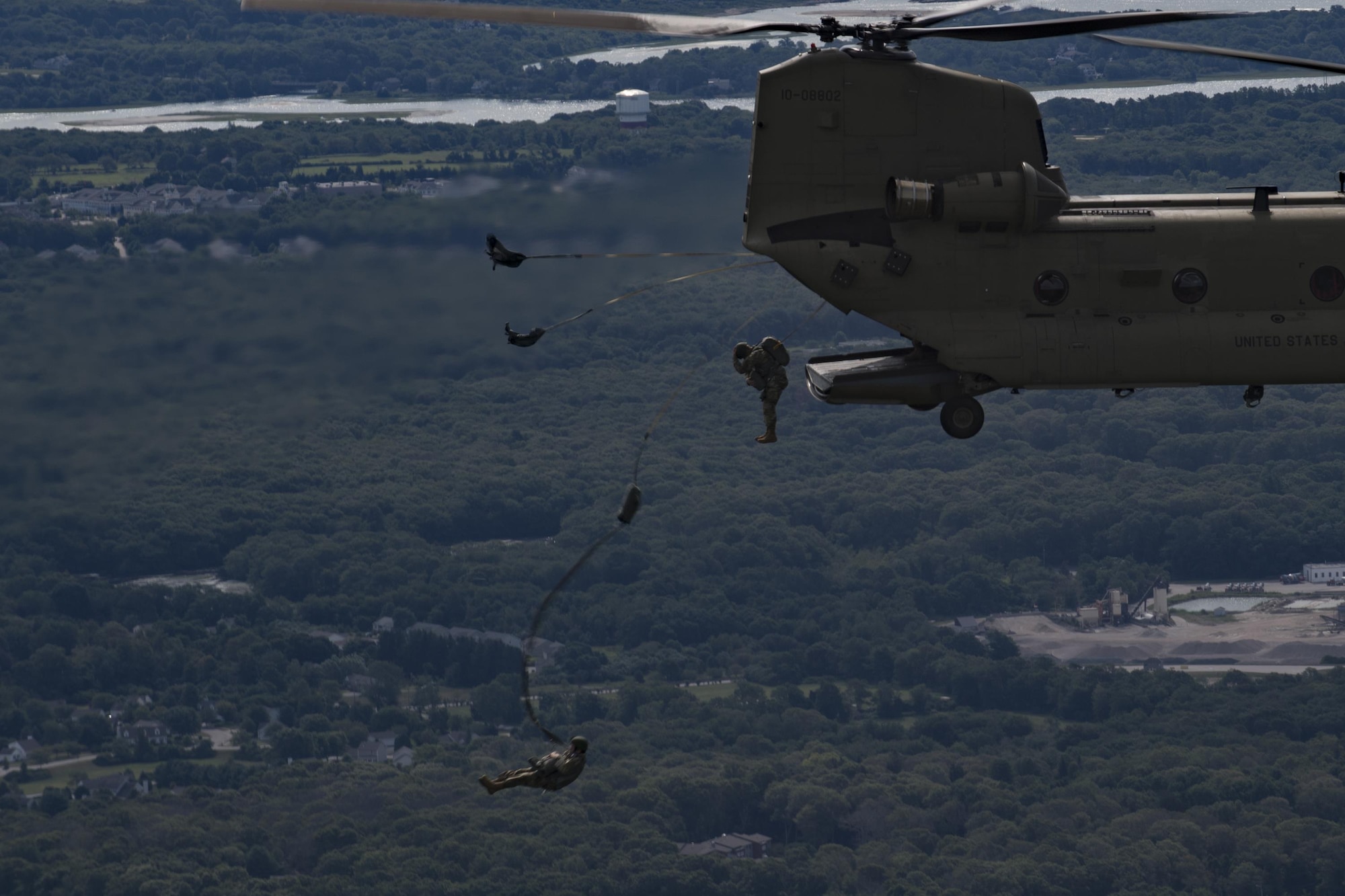 Paratroopers jump from a U.S. Army CH-47 Chi-nook during Leapfest, Aug. 6, 2017, in West Kingstown, R.I. The Rhode Island National guard hosted the 34th annual event, which is the largest international static line jump competition in the world. Team Moody’s Airmen represented the only U.S. sister-service team and earned second place among 70 participating teams. (U.S. Air Force photo by Airman 1st Class Daniel Snider)