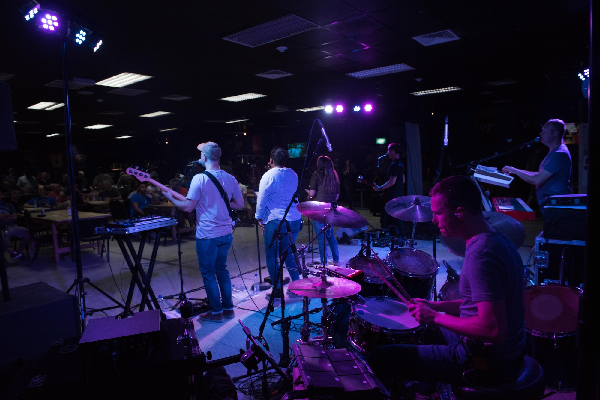 The AFCENT Band performs for a packed room full of U.S. and joint Coalition forces at an undisclosed location in Southwest Asia, August 7, 2017. The band’s high energy show and follow-on live band karaoke brought 386th Air Expeditionary Wing members and joint Coalition partners together for two nights of fun, laughter and fellowship.  (U.S. Air Force photo by Tech. Sgt. Jonathan Hehnly)