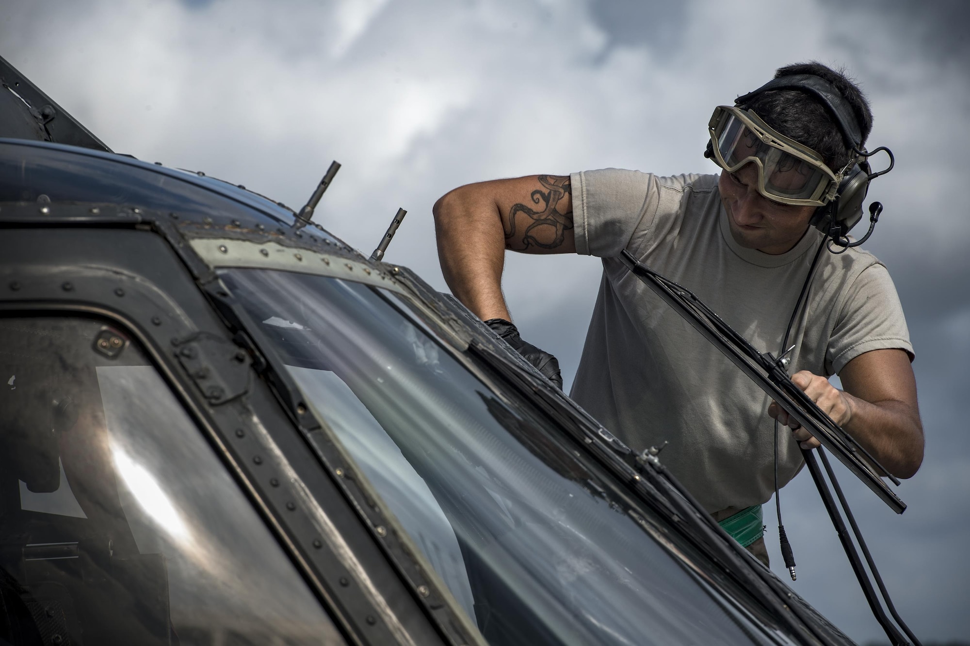 A maintainer from the 41st Helicopter Maintenance Unit washes a window on an HH-60G Pave Hawk, Aug. 8, 2017, at Tyndall Air Force Base, Fla.