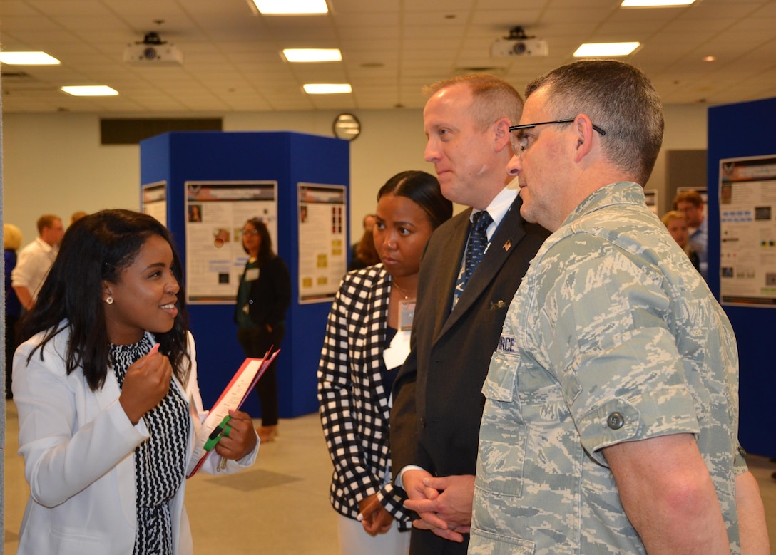 Summer students employed by the Materials and Manufacturing Directorate presented a culmination of their work at a poster session attended by leadership, mentors, and colleagues. (U.S. Air Force photo / Marisa Alia-Novobilski)