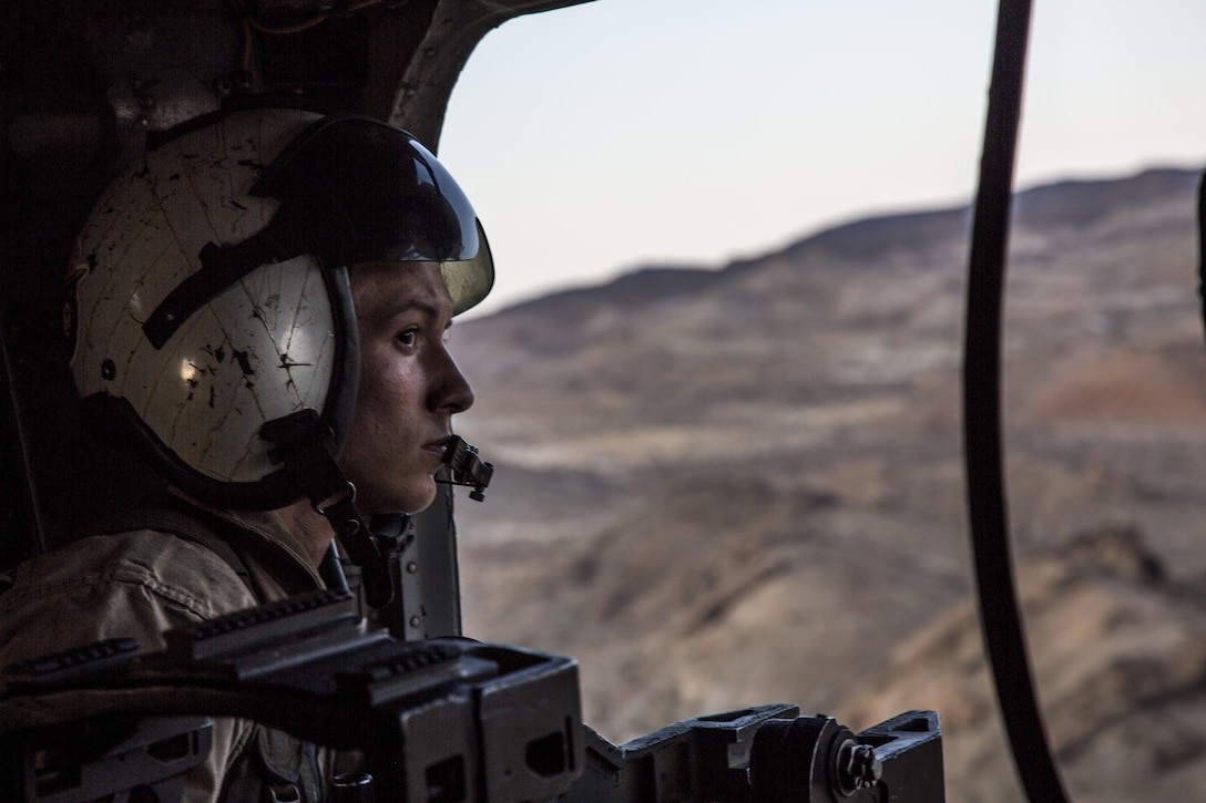 U.S. Marine Corps Cpl. Haelyn E. Holden, a crew chief with Marine Heavy Helicopter Squadron (HMH) 464, Marine Air Ground Task Force-8 (MAGTF-8) looks out the window of a CH-53E Super Stallion during a re-fuel mission to 1st Tank Battalion for Integrated Training Exercise (ITX) 5-17 at Marine Corps Air Ground Combat Center, Twentynine Palms, California, Aug. 5, 2017. The purpose of ITX is to create a challenging, realistic training environment that produces combat-ready forces capable of operating as an integrated MAGTF.