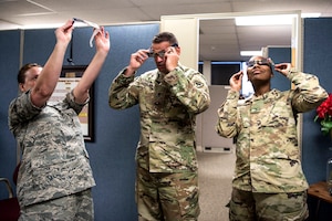 Members of the South Carolina National Guard test solar eclipse safety glasses.