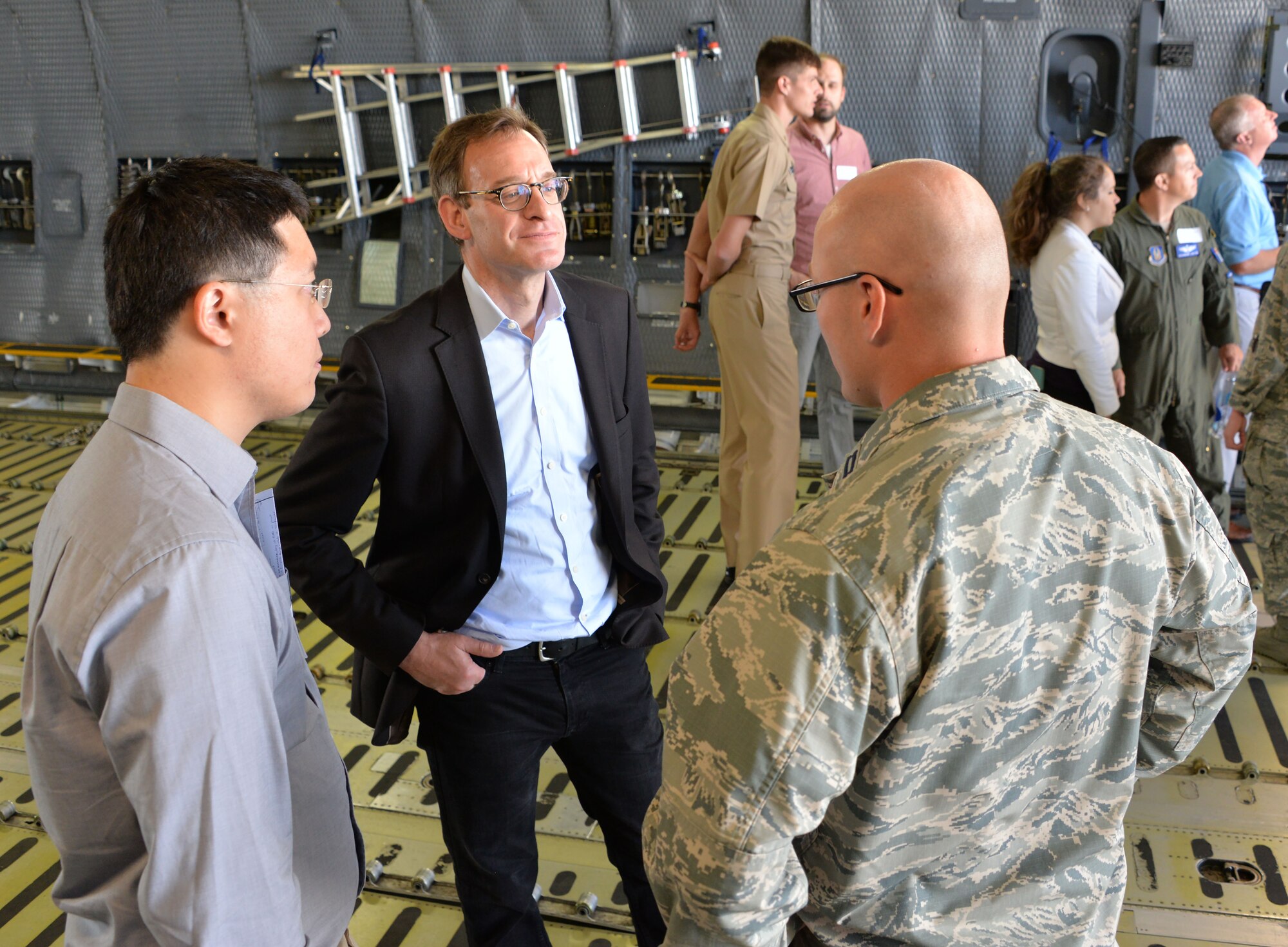 Capt. Garrett Custons (right), 60th Comptroller Squadron, talks with industry professionals during a tour of a C-5M Super Galaxy as part of a Phoenix Collider event at Travis Air Force Base, Calif., Aug. 1, 2017. Government and industry collaborations like Phoenix Collider are one of several avenues Phoenix Spark is pursuing to expand its footprint and develop solutions to enhance the lethality and efficiency of today’s warfighter. (U.S. Air Force photo/Staff Sgt. Charles Rivezzo)