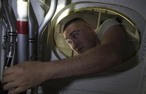 U.S. Air Force Staff Sgt. Jonathan Crowell, 86 Maintenance Squadron aircraft fuel systems craftsman, inspects the work of one of his Airmen in the dry bay of a fuel tank for a C-130J Super Hercules on Ramstein Air Base, Germany, Aug. 8, 2017. Crowell, along with two crews of 86 MXS Airmen, made a complete inspection of the four main fuel tanks for the C-130’s mandatory 12-year fuel tank inspection. (U.S. Air Force photo by Senior Airman Tryphena Mayhugh)