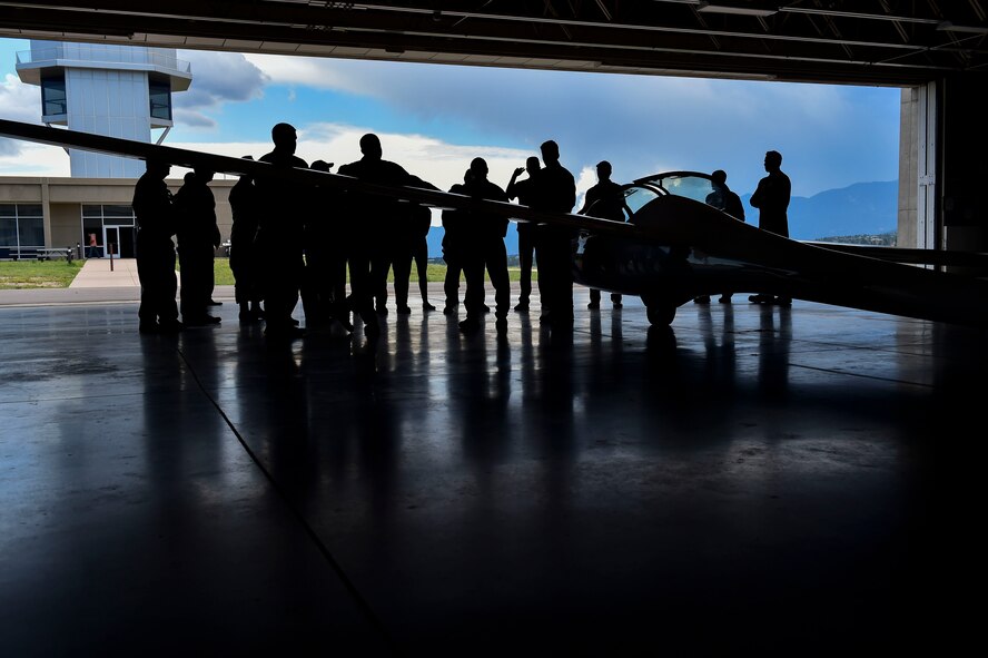 Civic leaders meet with U.S. Air Force Academy Cadets around a TG-16 glider and talk about what its like to be a cadet July 28, 2017.
