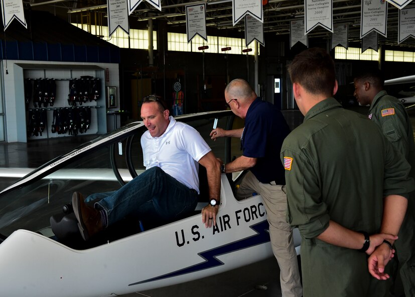 Two civic leaders climb into a TG-16 glider July 28, 2017, at the U.S. Air Force Academy, Colorado. The majority of cadets will participate in the Introduction to Soaring Program, which includes four glider flights and the opportunity for aerobatic flight.