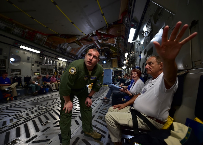 Tech. Sgt. Scott Schaffner, a loadmaster from the 89th AS, answers a question of a YARS civic leader July 28, 2017, aboard a C-17 on a flight to Colorado.