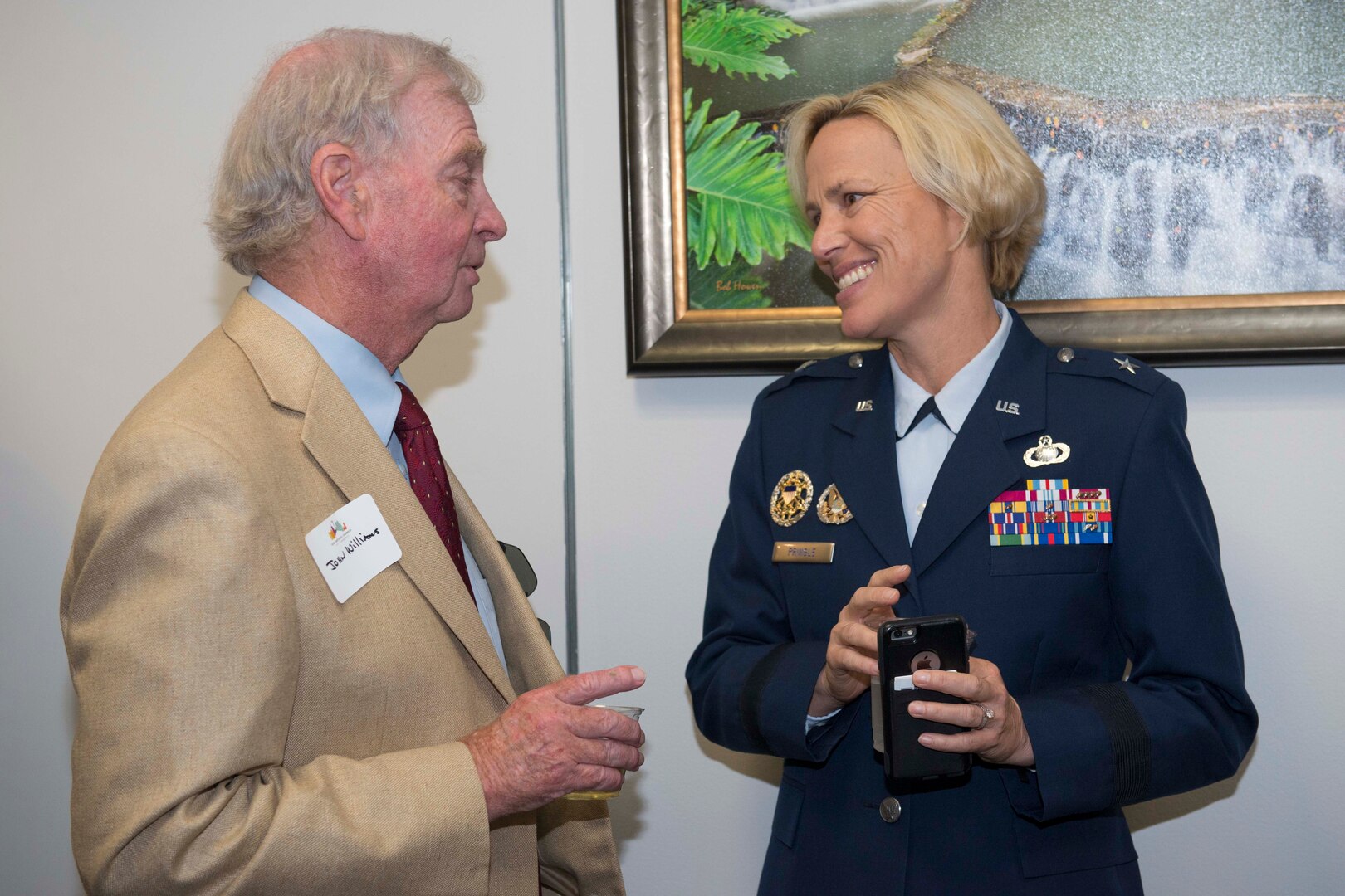 Brig. Gen. Heather Pringle, 502nd Air Base Wing and Joint Base San Antonio commander, speaks with John Williams, Universal City mayor, prior to the presentation of the Altus Trophy at the San Antonio Chamber of Commerce Aug. 8, 2017.