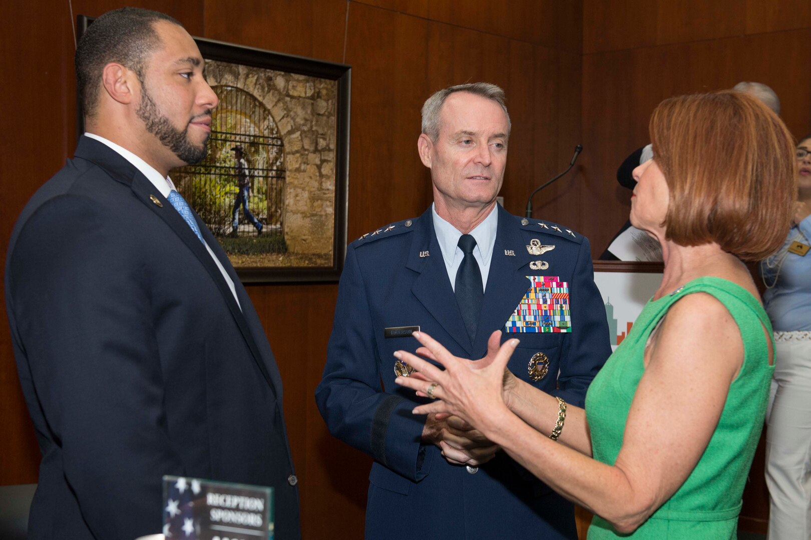 Lt. Gen. Darryl Roberson, commander of Air Education and Training Command, speaks with Tommy Calvert (left), Bexar County commissioner, and Diane Rath, AACOG executive director, prior to the presentation of the Altus Trophy at the San Antonio Chamber of Commerce Aug. 8, 2017.