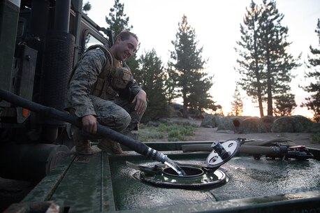 BRIDGEPORT, Calif.- U.S. Marine Lance Cpl. Jack Cohen, a motor transportation operator with Combat Logistics Battalion 5 (CLB-5), Combat Logistics Regiment 1, 1st Marine Logistics Group, transfers water from one SIXCON water storage tank to another during a convoy as part of Mountain Training Exercise 4-17 at the Marine Corps Mountain Warfare Training Center, Aug. 2, 2017. (U.S. Marine Corps photo by Lance Cpl. Timothy Shoemaker)