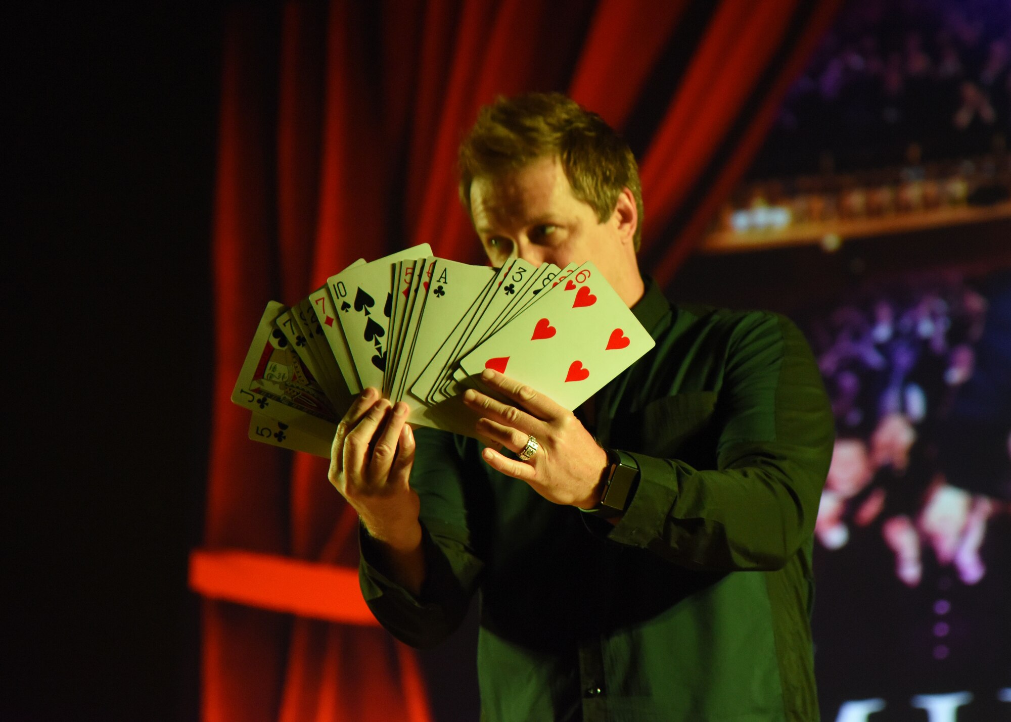 Mike Super, illusionist, performs a card trick during the Mike Super’s Magic & Illusion show in the Welch Theater July 29, 2017, on Keesler Air Force Base, Miss. Super, an American magician who is the winner of the NBC show Phenomenon, is currently touring the U.S. and Canada with his illusion show. (U.S. Air Force photo by Kemberly Groue)