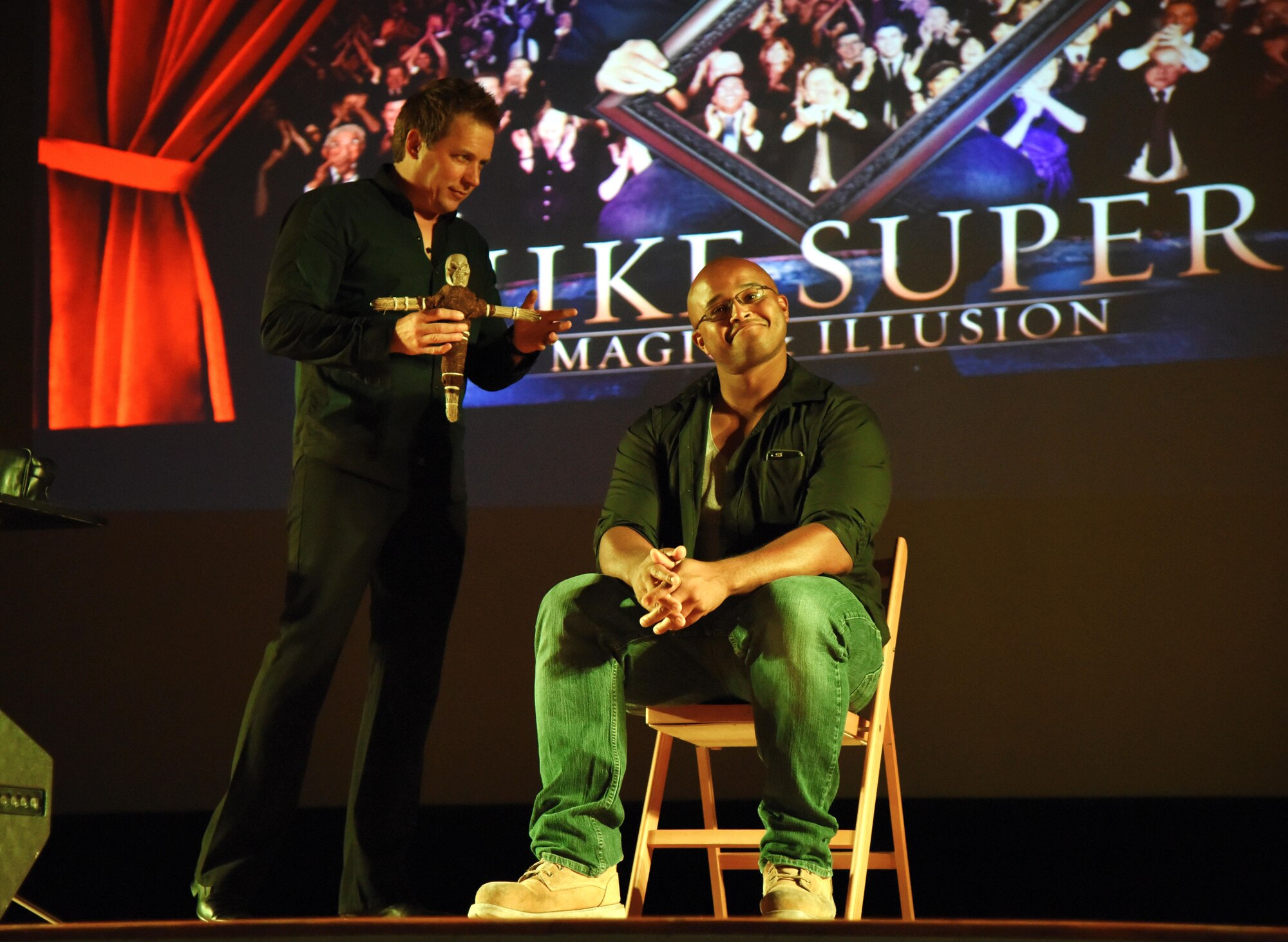 Mike Super, illusionist, performs an illusion with the assistance of Petty Officer 2nd Class Melvin Nelson, Coast Guard Station New Orleans boatswain mate, during the Mike Super’s Magic & Illusion show in the Welch Theater July 29, 2017, on Keesler Air Force Base, Miss. Super, an American magician who is the winner of the NBC show Phenomenon, is currently touring the U.S. and Canada with his illusion show. (U.S. Air Force photo by Kemberly Groue)