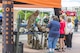 An explosive ordnance technician with the 788th Explosive Ordnance Disposal unit from Wright-Patterson Air Force Base, Ohio, explains his unit’s mission and equipment used which is on display outside Fifth Third Field in downtown Dayton prior to the Dayton Dragons salute to hometown heroes, Aug. 5, 2017. In addition to being able to visit the EOD tent, people were also able to get inside a Humvee from the 88th Security Forces Squadron, a fire truck from the 788th Civil Engineer Squadron Fire Department among other booths.  (U.S. Air Force photo/ Wesley Farnsworth)