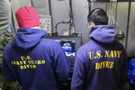 Coast Guard Petty Officer 2nd Class Adam Harris and Navy Petty Officer 2nd Class Matthew Villafuerte, divers deployed on the Coast Guard Cutter Healy, conduct remote operated vehicle operations in search of the wreckage from the fishing vessel Destination, in the Bering Sea, near St. George, Alaska, July 24, 2017. The Destination and its six crew members were lost February 11, 2017. U.S. Coast Guard photo by Petty Officer 2nd Class Meredith Manning