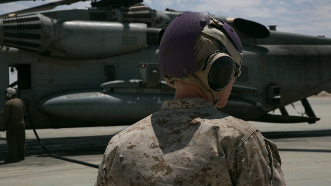 A Marine with Marine Wing Support Squadron 272, observes a hot refuel at the Strategic Expeditionary Landing Field at the Combat Center during Integrated Training Exercise 5-17, July 29, 2017. MWSS-272 is supporting the Aviation Combat Element of the ITX. The ACE conducts offensive, defensive, and all other air operations to support the MAGTF mission .