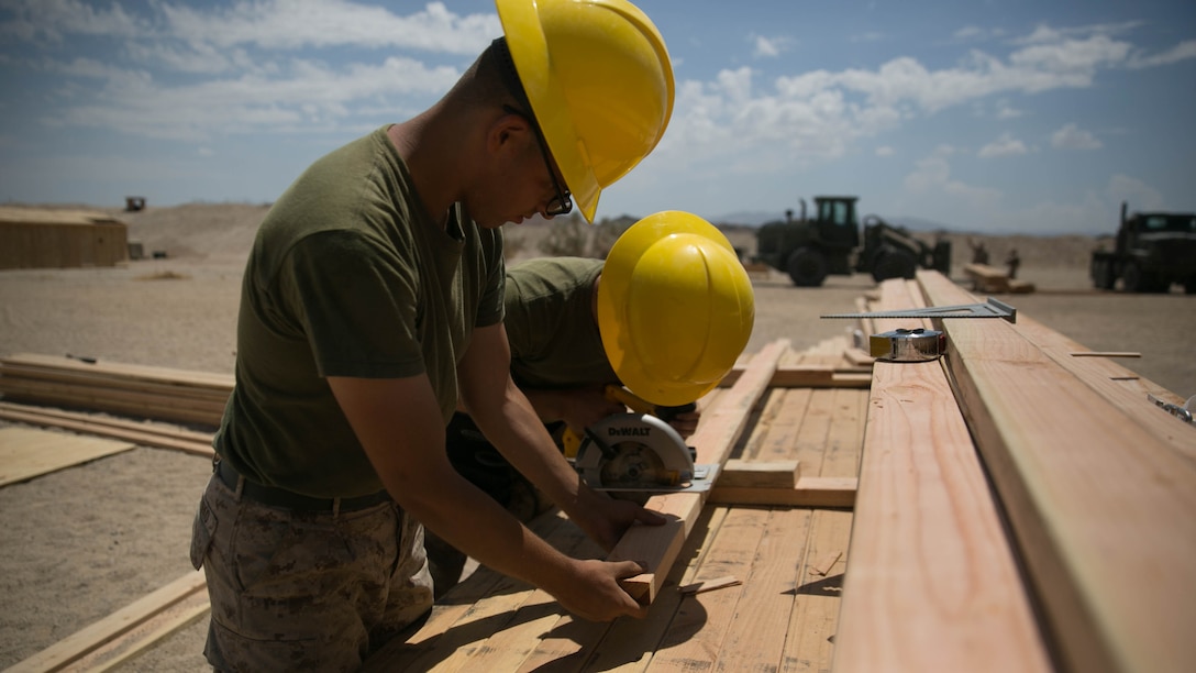 Marines with the engineer platoon for Marine Wing Support Squadron 272, cut wood for a Southwest Asia hut at the Combat Center during Integrated Training Exercise 5-17, July 29, 2017. MWSS-272 is supporting the Aviation Combat Element of the ITX. The ACE conducts offensive, defensive, and all other air operations to support the MAGTF mission .