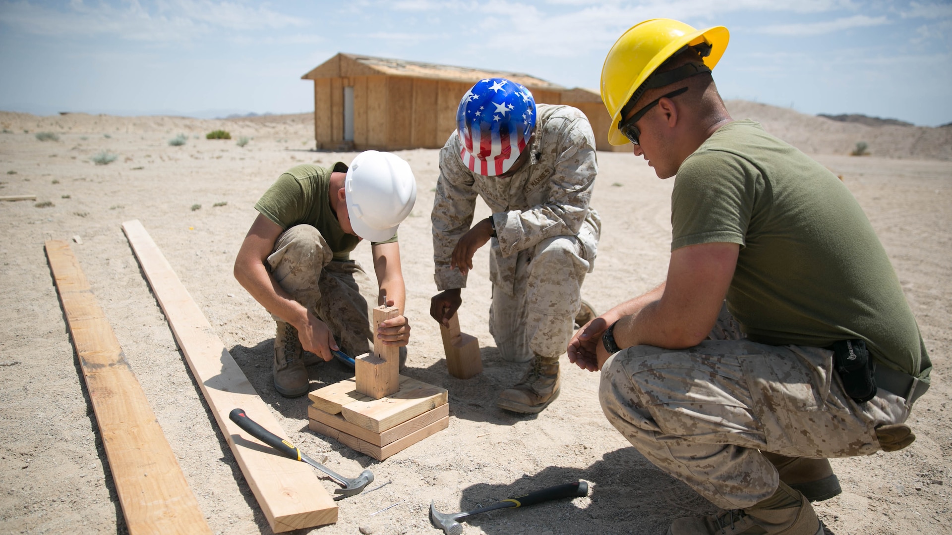 Marines with the engineer platoon for Marine Wing Support Squadron 272, construct a foundation for a Southwest Asia hut at the Combat Center during Integrated Training Exercise 5-17, July 29, 2017. MWSS-272 is supporting the Aviation Combat Element of the ITX. The ACE conducts offensive, defensive, and all other air operations to support the MAGTF mission .