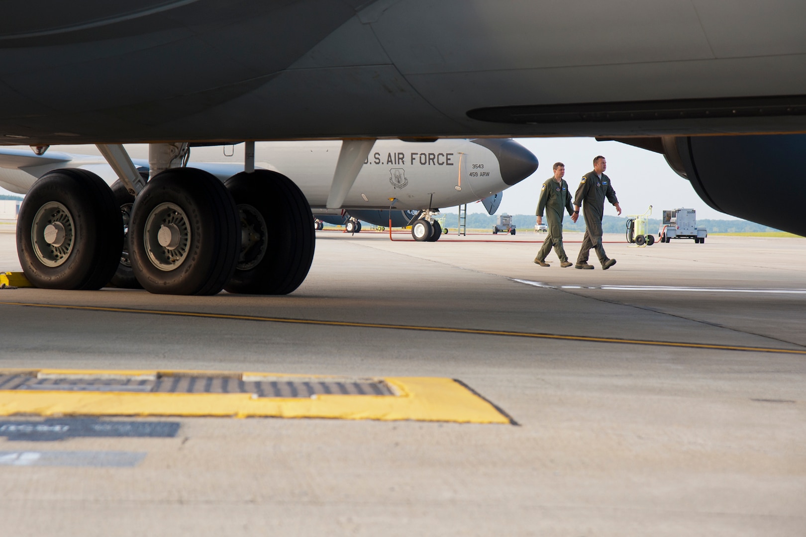 Boom operators make their way to a KC-135 prior to takeoff.