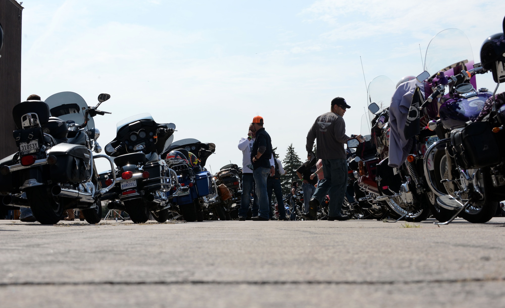 Bikers gather and talk about their motorcycles before riding to the Sturgis Veterans Appreciation Ceremony Aug. 8, 2017 on Ellsworth Air Force Base, S.D. This is the 17th Annual Dakota Thunder run and is hosted by the Green Knights Military Motorcycle Club. (U.S. Air Force photo by Airman 1st Class Thomas Karol)