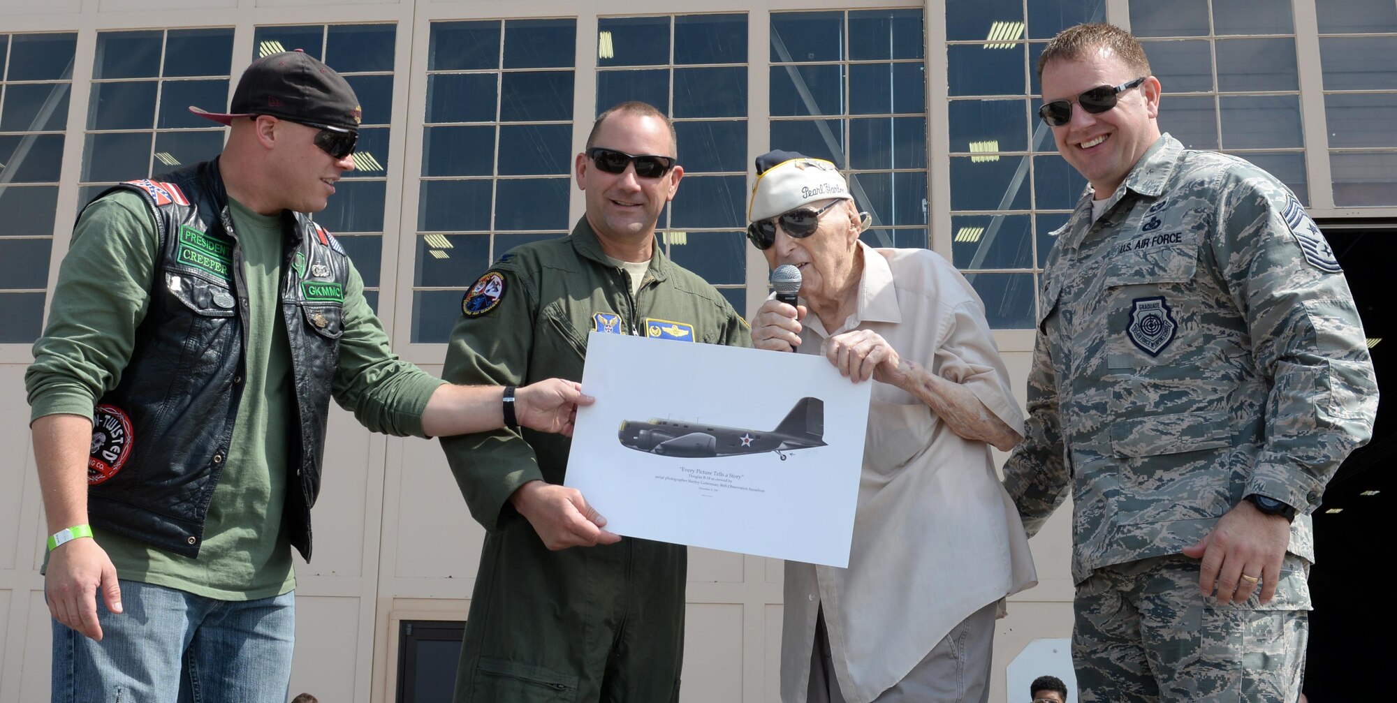 Stan Lieberman stands alongside Col. Gentry Boswell, former 28th Bomb Wing commander, Chief Master Sgt Adam Vizi, 28th BW command chief and Tech. Sgt. Tylor Evans, response force leader assigned to the 28th Security Forces Squadron and president of the Green Knights Military Motorcycle Club, Aug. 8, 2017 on Ellsworth Air Force Base, S.D. Lieberman is a Pearl Harbor survivor and one of only two World War II veterans in South Dakota.  (U.S. Air Force photo by Airman 1st Class Thomas Karol)