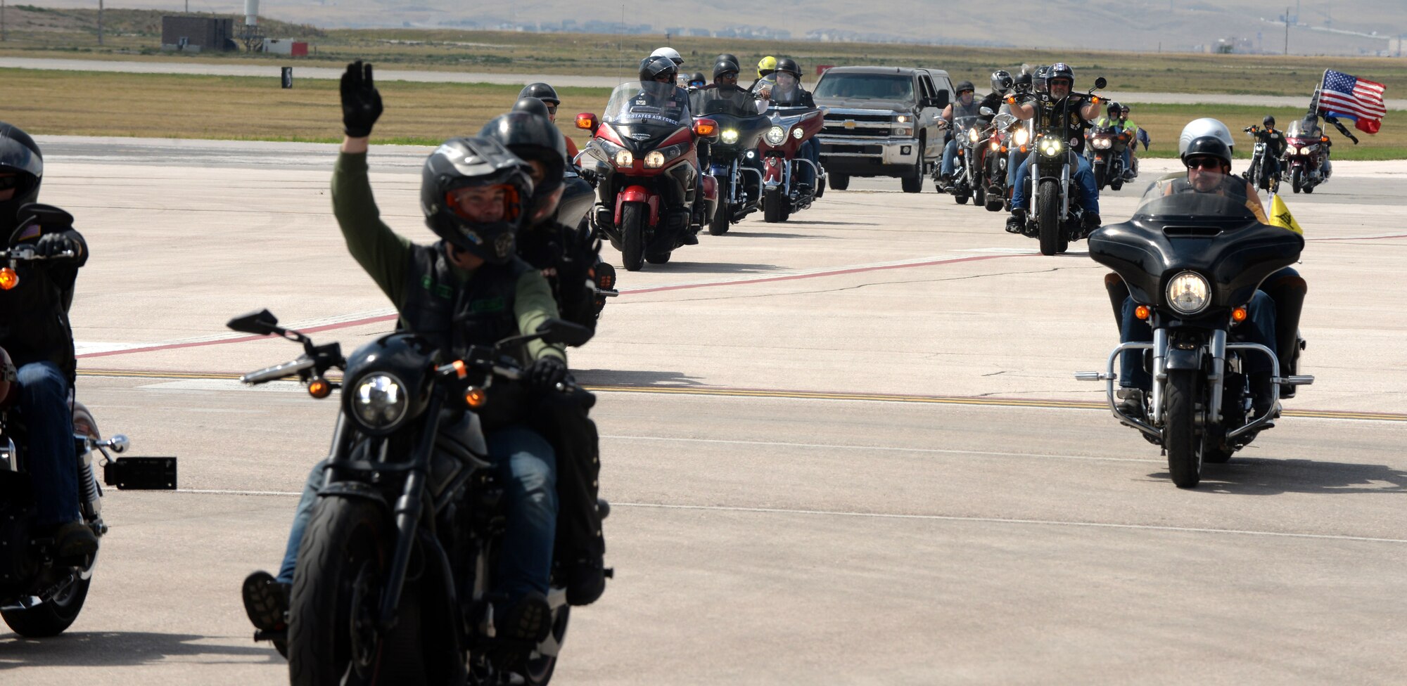 Motorcyclists begin the Dakota Thunder Run and exit the runway Aug 8, 2017 on Ellsworth Air Force Base, S.D. The ride started Ellsworth and ended at the Sturgis Veterans Appreciation Ceremony with stops in Nemo and Vanocher Canyon. (U.S. Air Force photo by Airman 1st Class Thomas Karol)