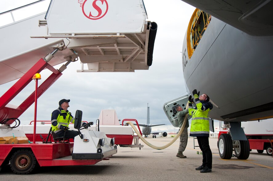 South Air ground operations officers guide a set of air stairs toward a 459th Air Refueling Wing KC-135R Stratotanker that had just landed on the Keflavík International Airport flight line Aug. 3, 2107. Two KC-135s and their crews embarked on a mission last week to provide en route refueling support to 175th Wing Maryland National Guard A-10C Thunderbolt IIs as the ANG unit made its way to Estonia to participate in a state partnership program. (U.S. Air Force photo/Tech. Sgt. Kat Justen)