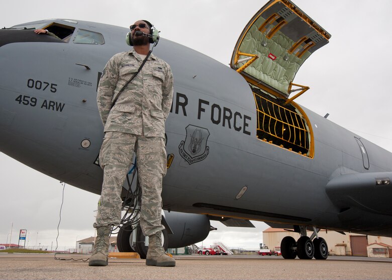 Staff Sgt. Robert Washington, 459th Maintenance Squadron crew chief, waits for passengers to arrive on the Keflavík International Airport, Iceland, flight line prior to a mission to Estonia Aug. 4, 2017.